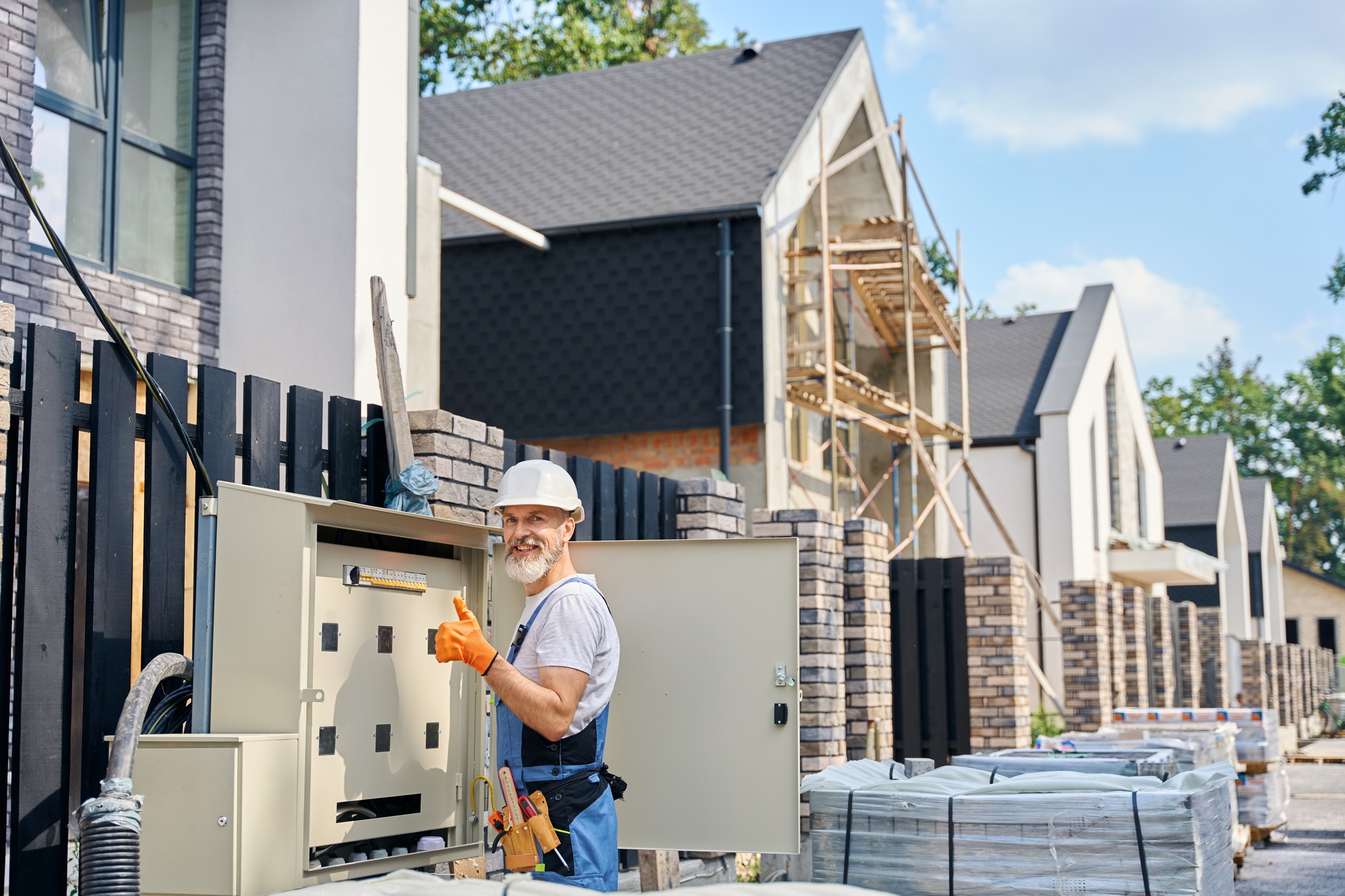 Electrical engineer approving power distribution box installation on site