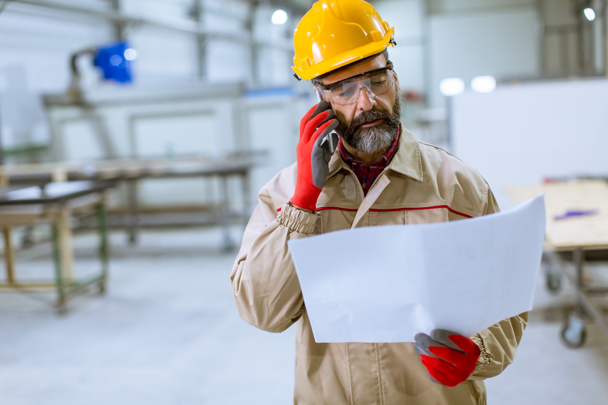 Engineer looking at plan in the factory