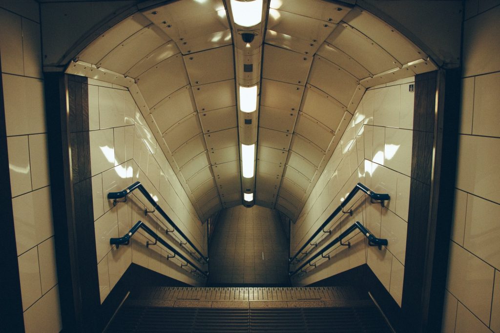 Tube. Underground. Subway. Station. Steps and staircases. Lighting equipment. High angle view.